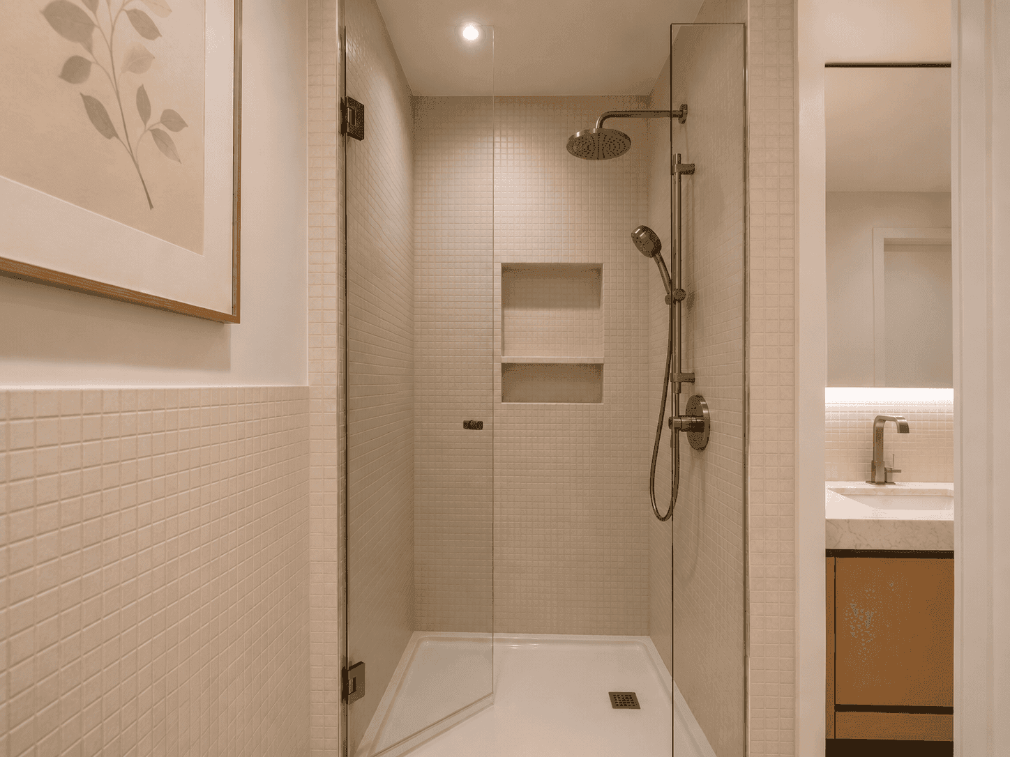 Walk-in shower renovation with rain shower, recessed niche and frameless glass in Dubai Hills apartment