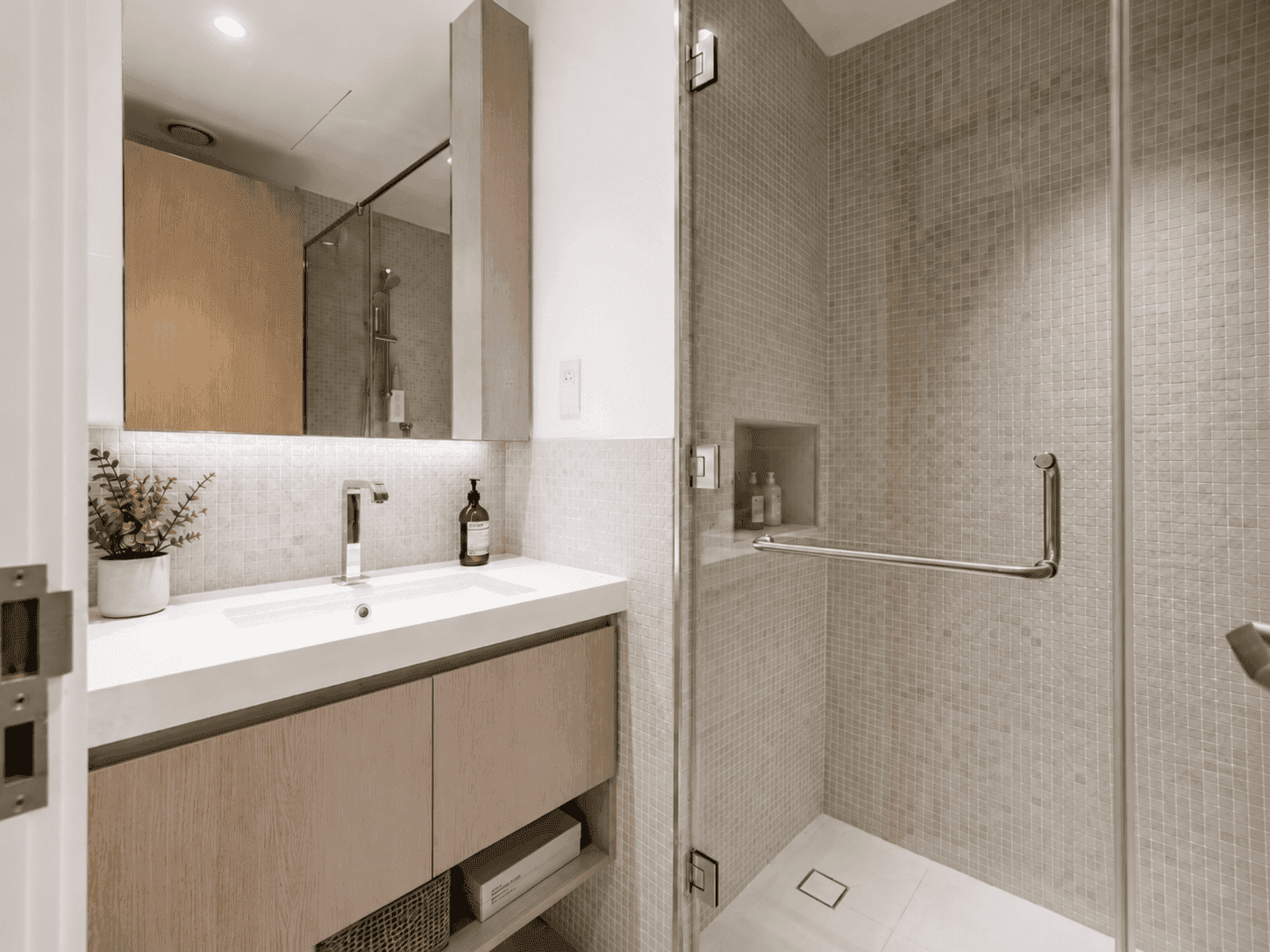 Family bathroom fit-out with oak vanity, mosaic shower enclosure and mirrored cabinet in Acacia B apartment