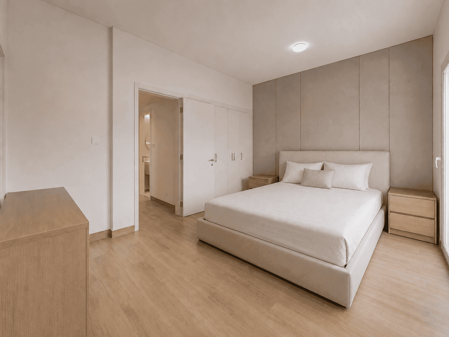 Second bedroom renovation with upholstered panel wall and en-suite bathroom in The Lakes villa, Dubai