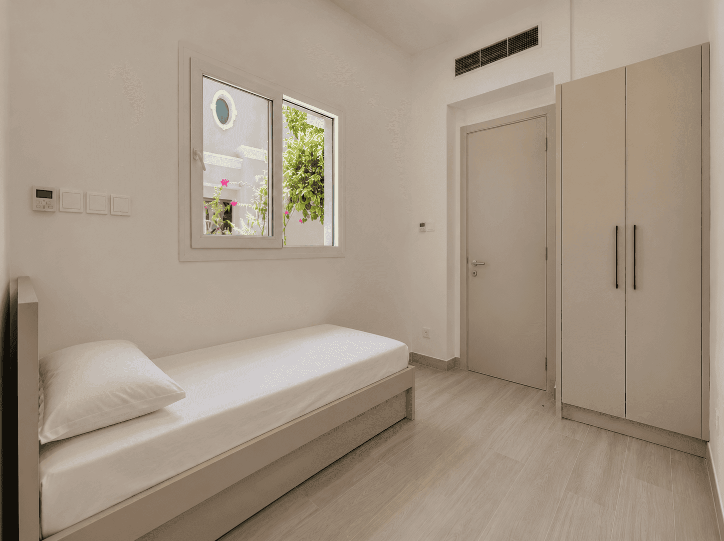 Renovated maid's room with single bed, built-in wardrobe and garden window in The Lakes villa, Dubai