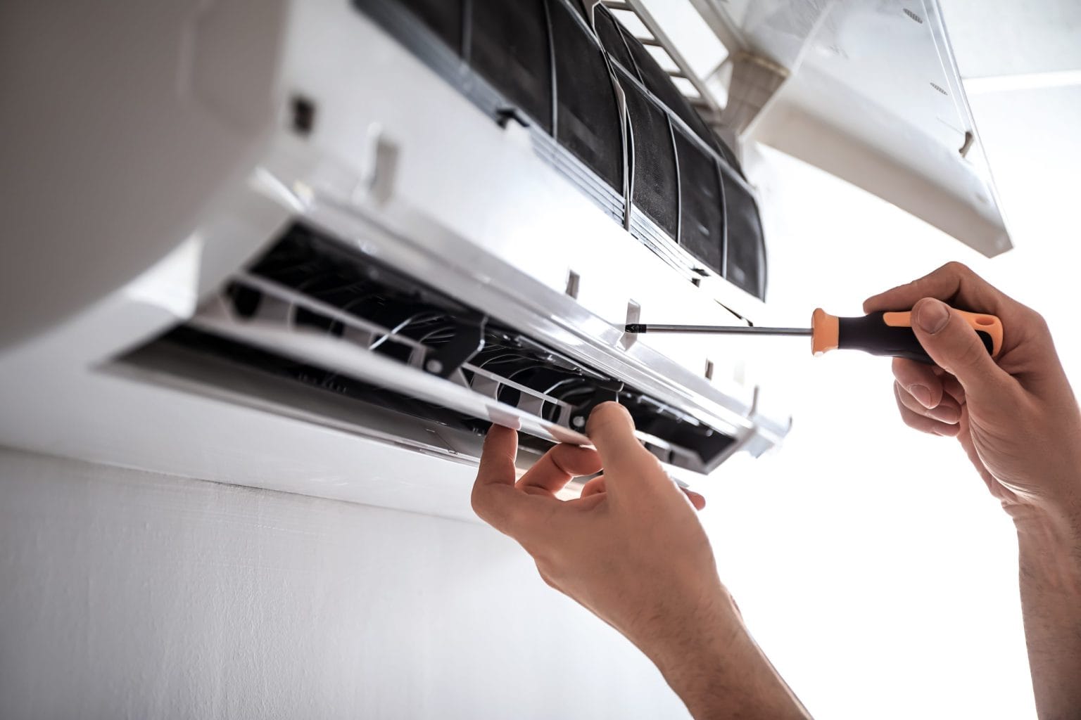 Removing the front cover from a wall-mounted split indoor unit