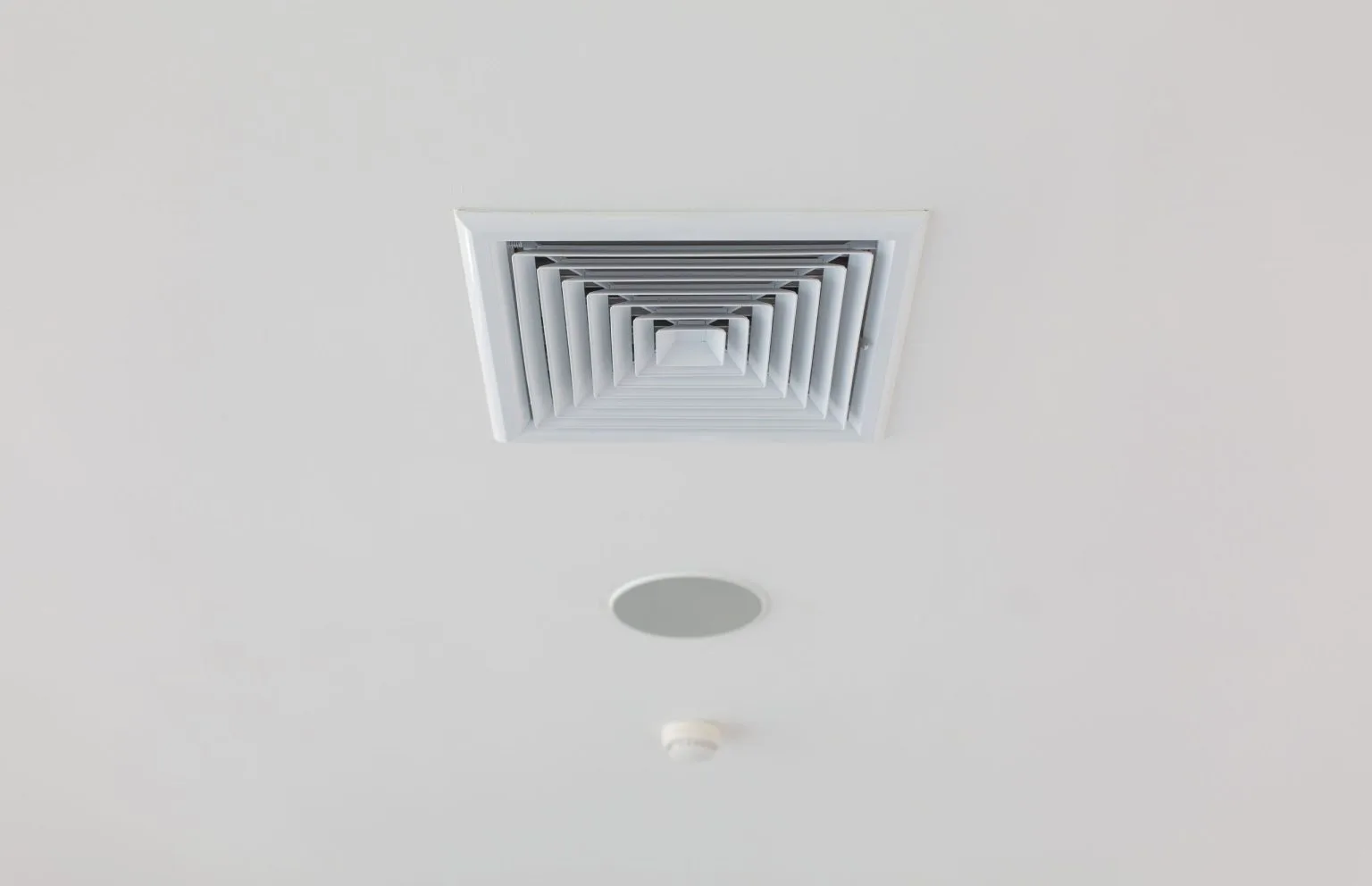 Ceiling mounted ventilation diffuser installed during bathroom plumbing and electrical first fix in Dubai