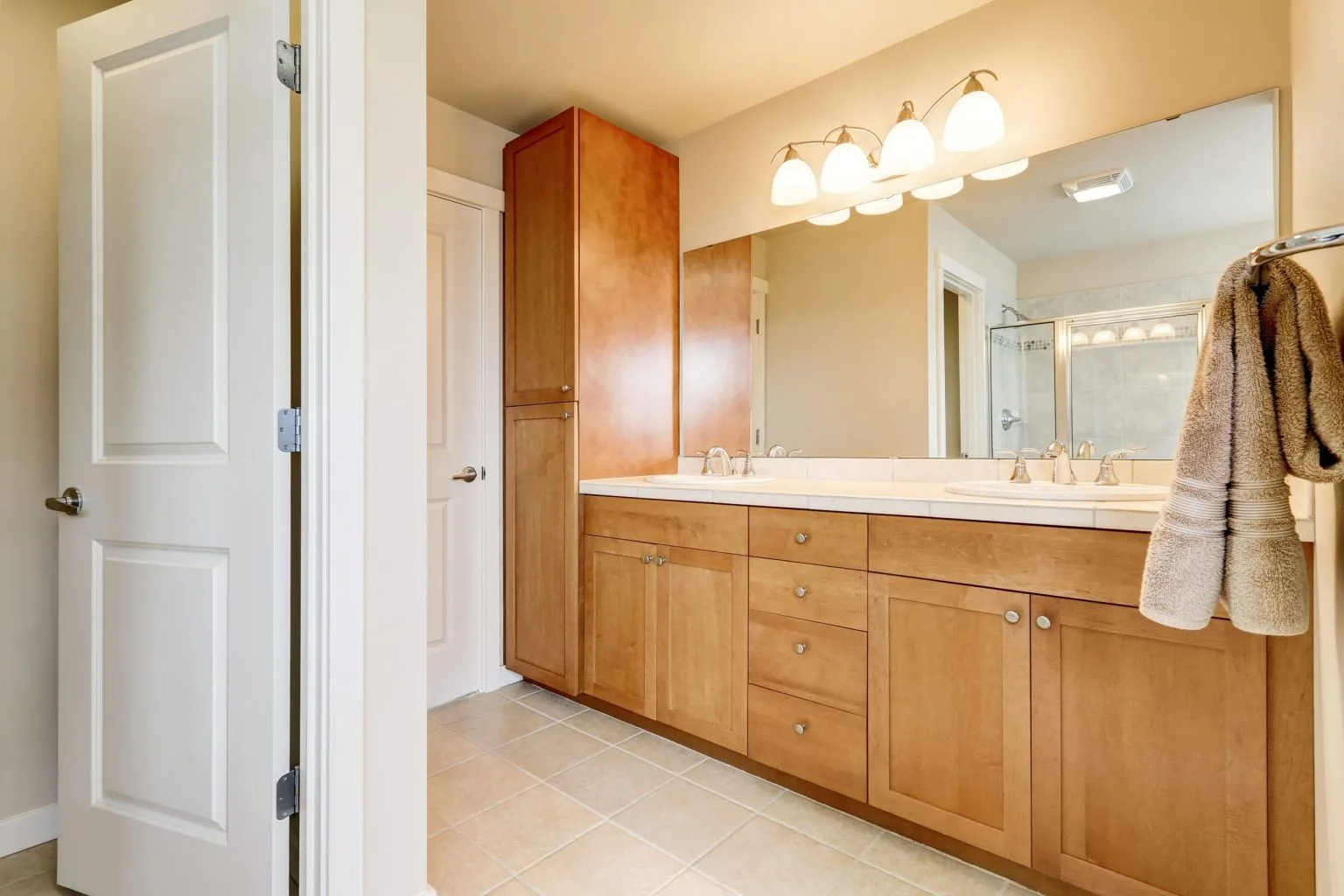 Dated double maple wood vanity in a Dubai bathroom before a sanitary ware and fittings upgrade