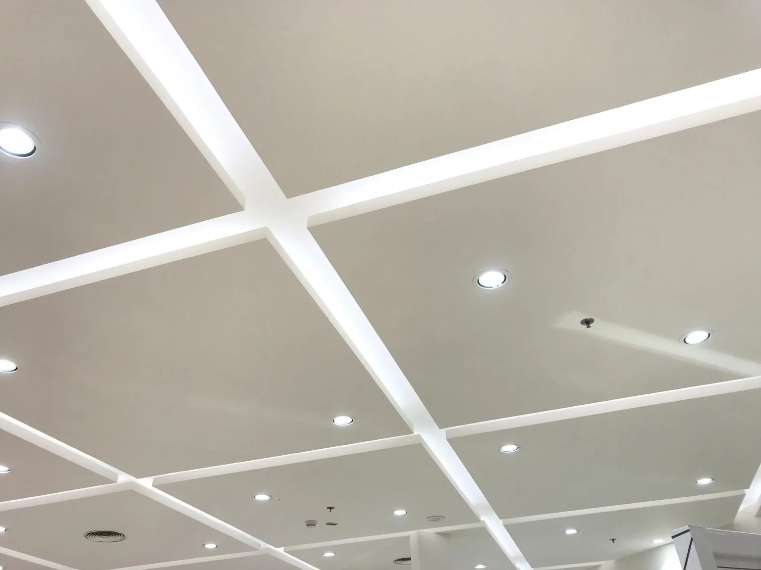 Commercial coffered gypsum false ceiling with recessed downlights in a Dubai office