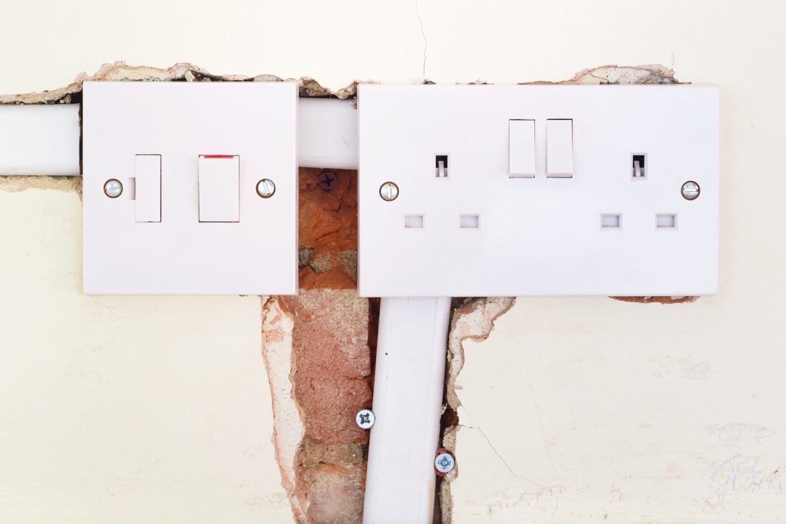 Switch and socket plates fitted to a chased wall