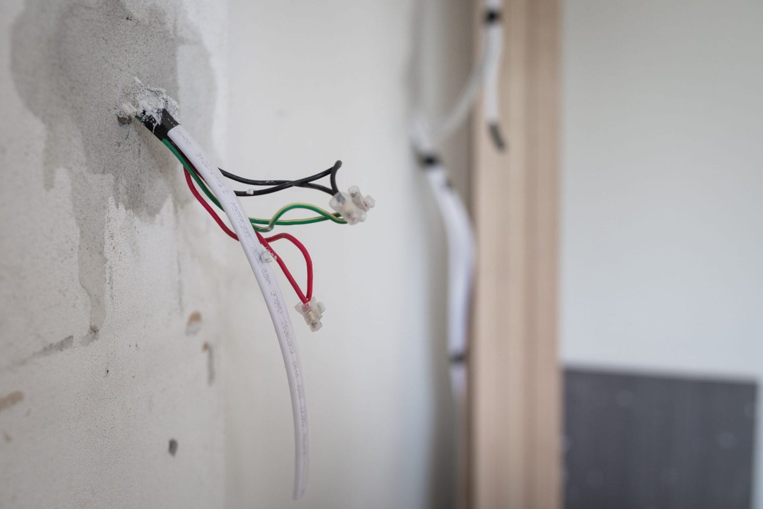 Cables pulled out of a chased wall ready for termination