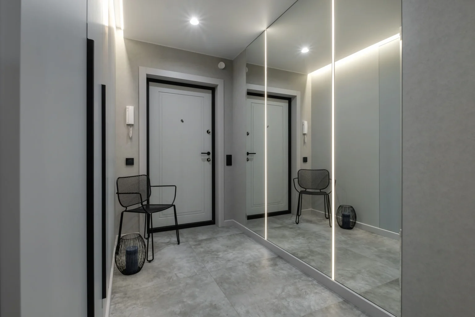 Full-height mirrored wardrobe doors lining a Dubai corridor