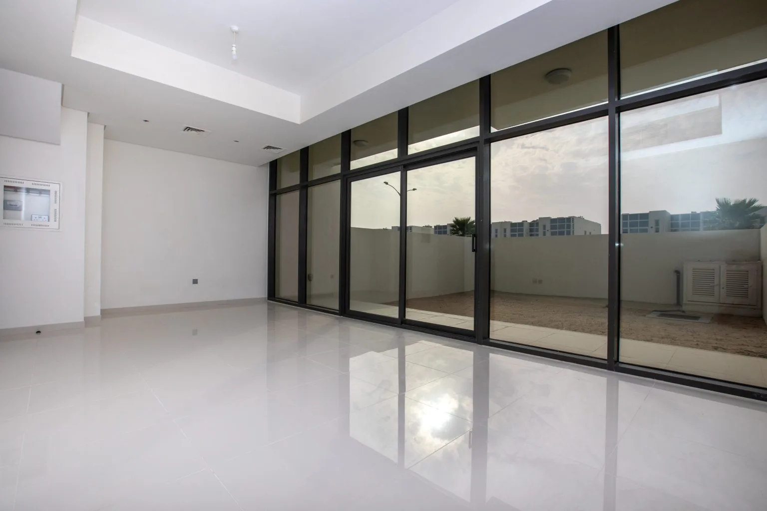 Black-framed full-height glazing and sliding doors in a Dubai apartment