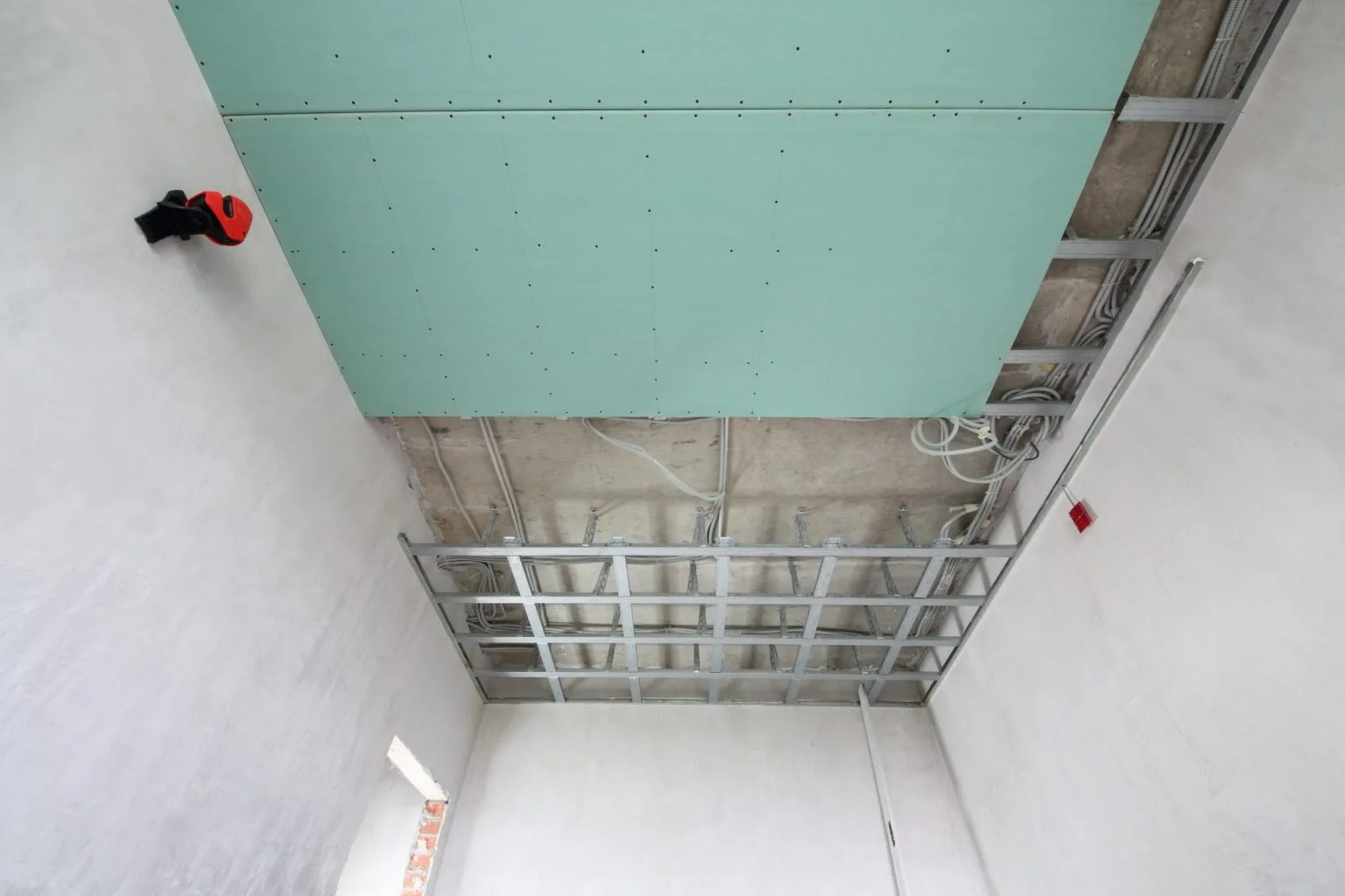 Suspended ceiling grid and gypsum board being installed in a Dubai building