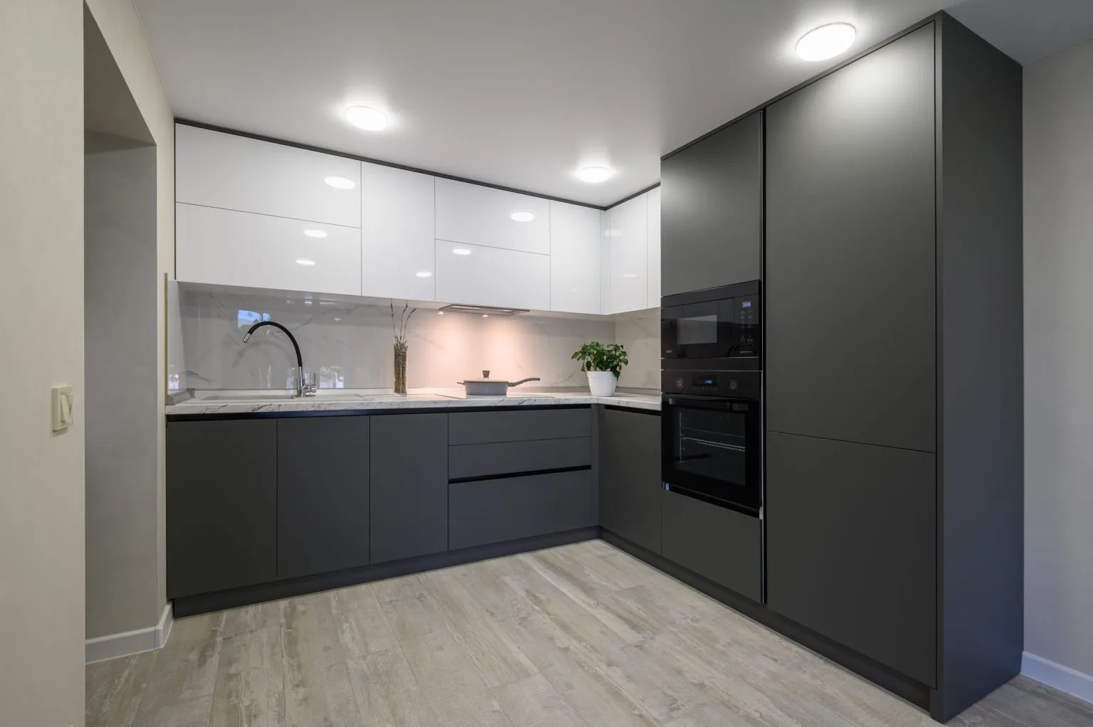 Handleless gloss and matt fitted kitchen cabinetry cut and edged in a Dubai joinery workshop