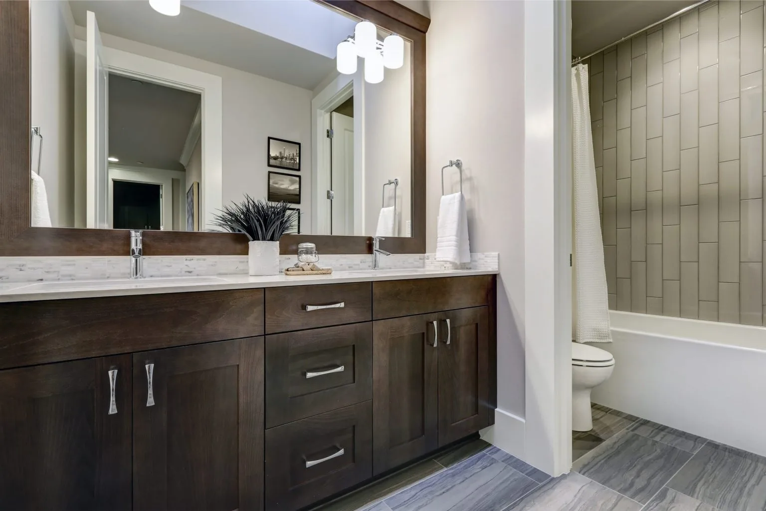 Custom double vanity unit with a framed mirror surround built by a joinery company in Dubai