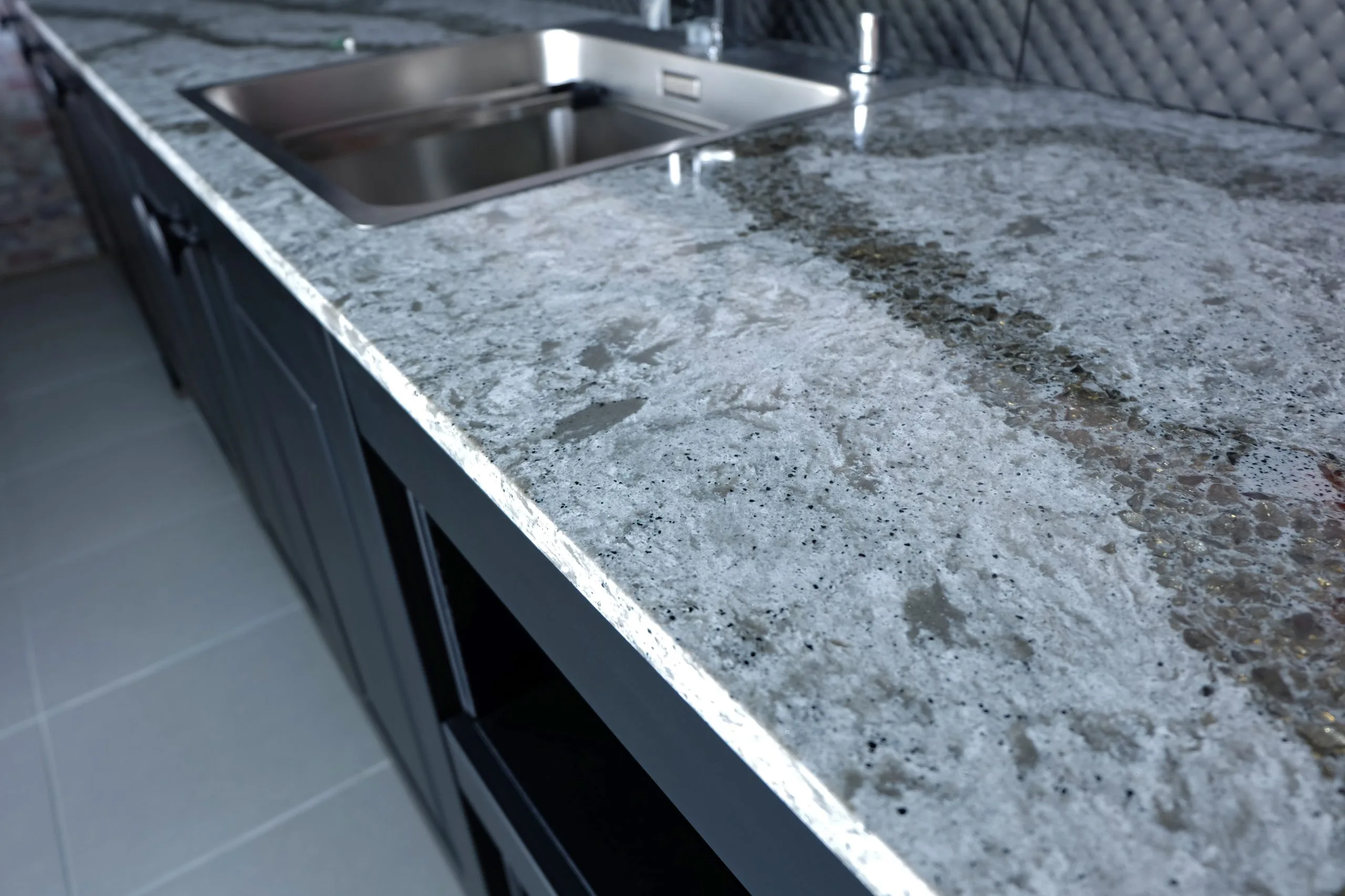 Granite worktop with undermount kitchen sink installation, part of a kitchen renovation Dubai project