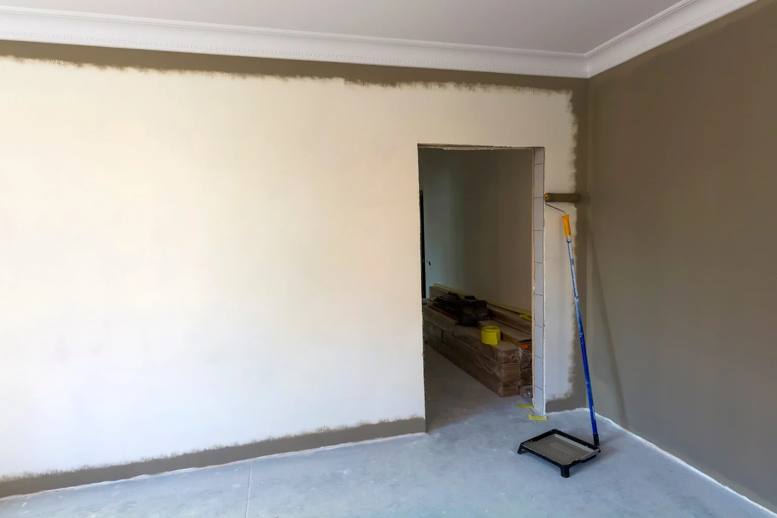 House painting in progress on a Dubai villa interior, walls rolled in a warm neutral shade