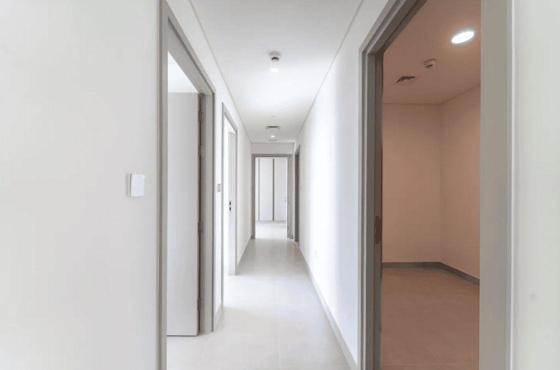 Bright renovated hallway with new doors, porcelain flooring and fresh paint in Dubai Creek Harbour apartment