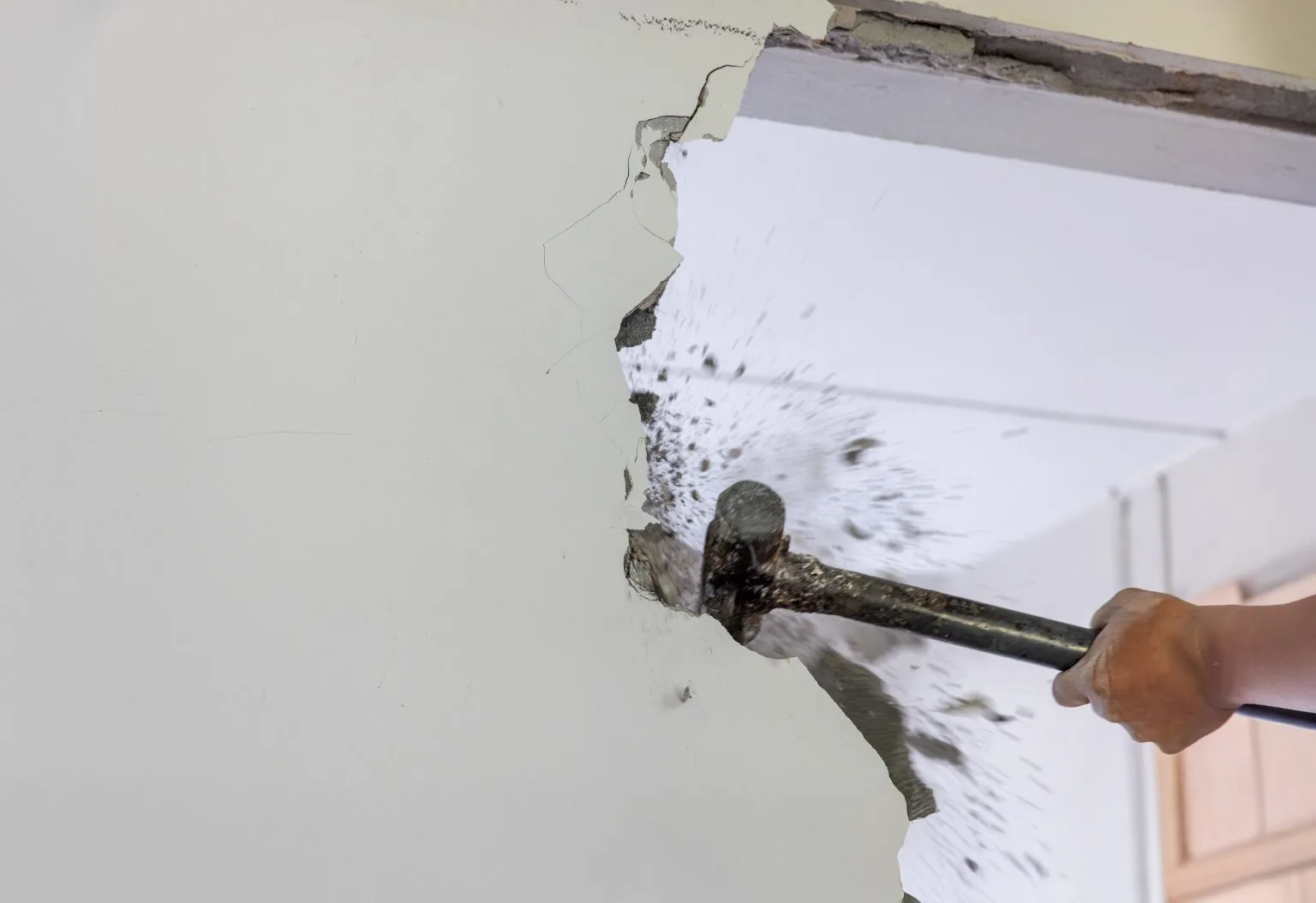 Plaster and blockwork chiselled back along a wall line before demolition in Dubai