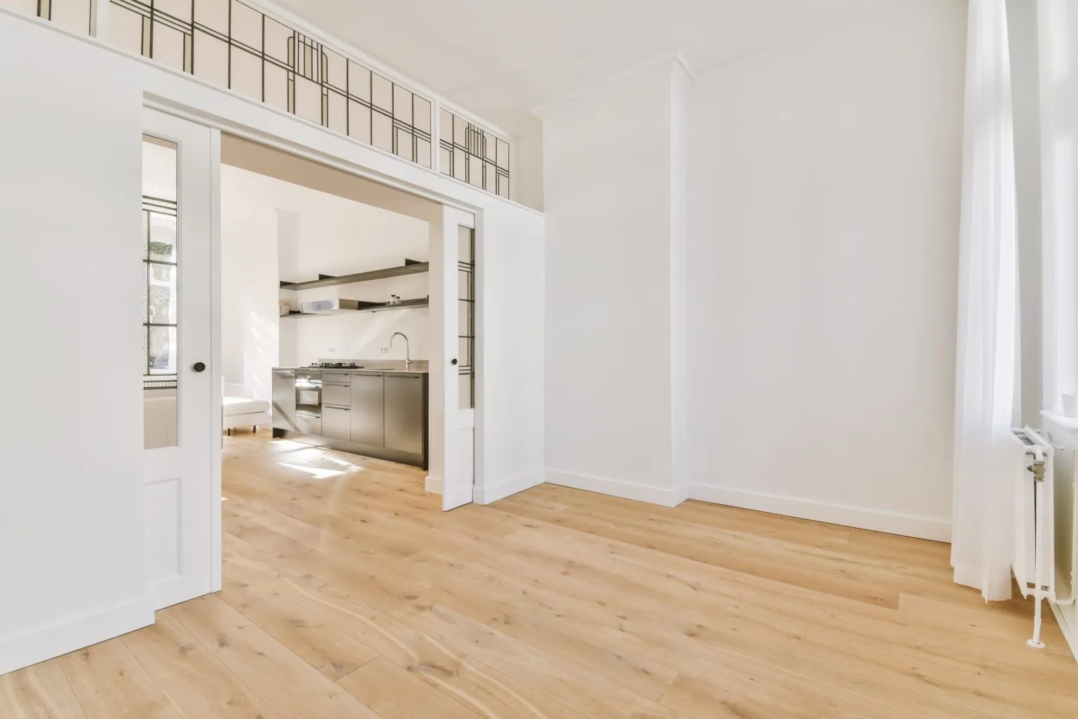 Framed opening with a decorative grille looking through to a kitchen