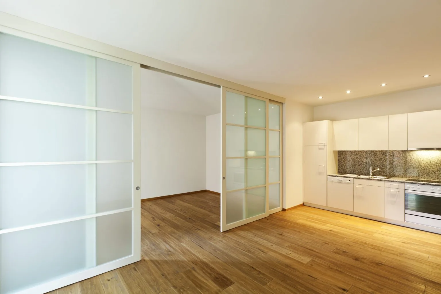 Frosted glass sliding doors running on a surface-mounted track
