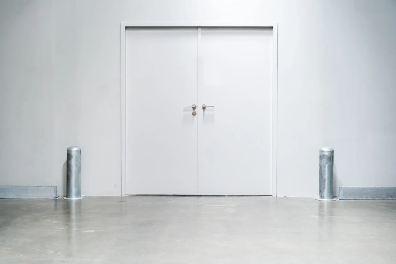 White steel double doors installed in a Dubai warehouse