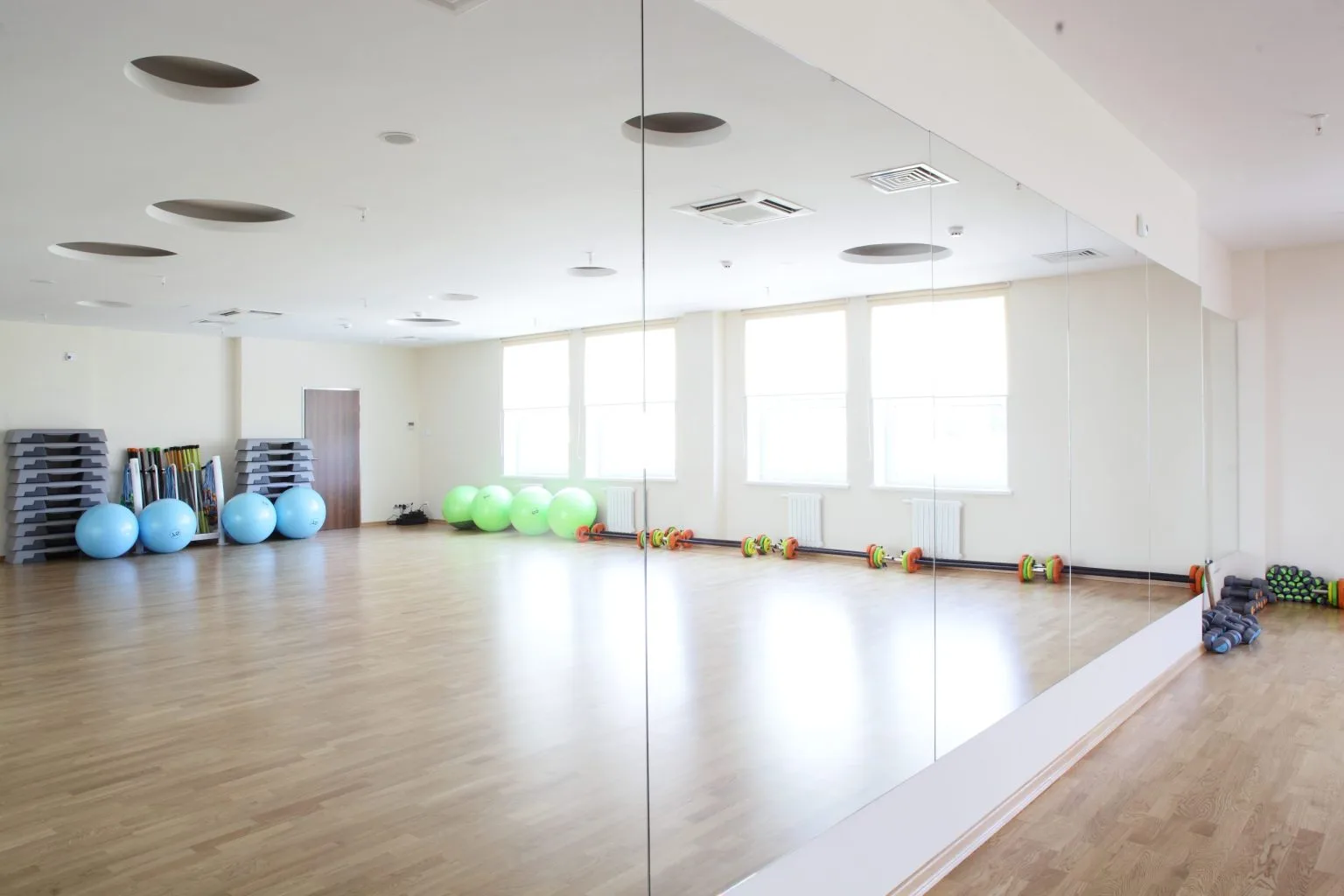 Full-height gym mirror wall installed in a Dubai fitness and dance studio