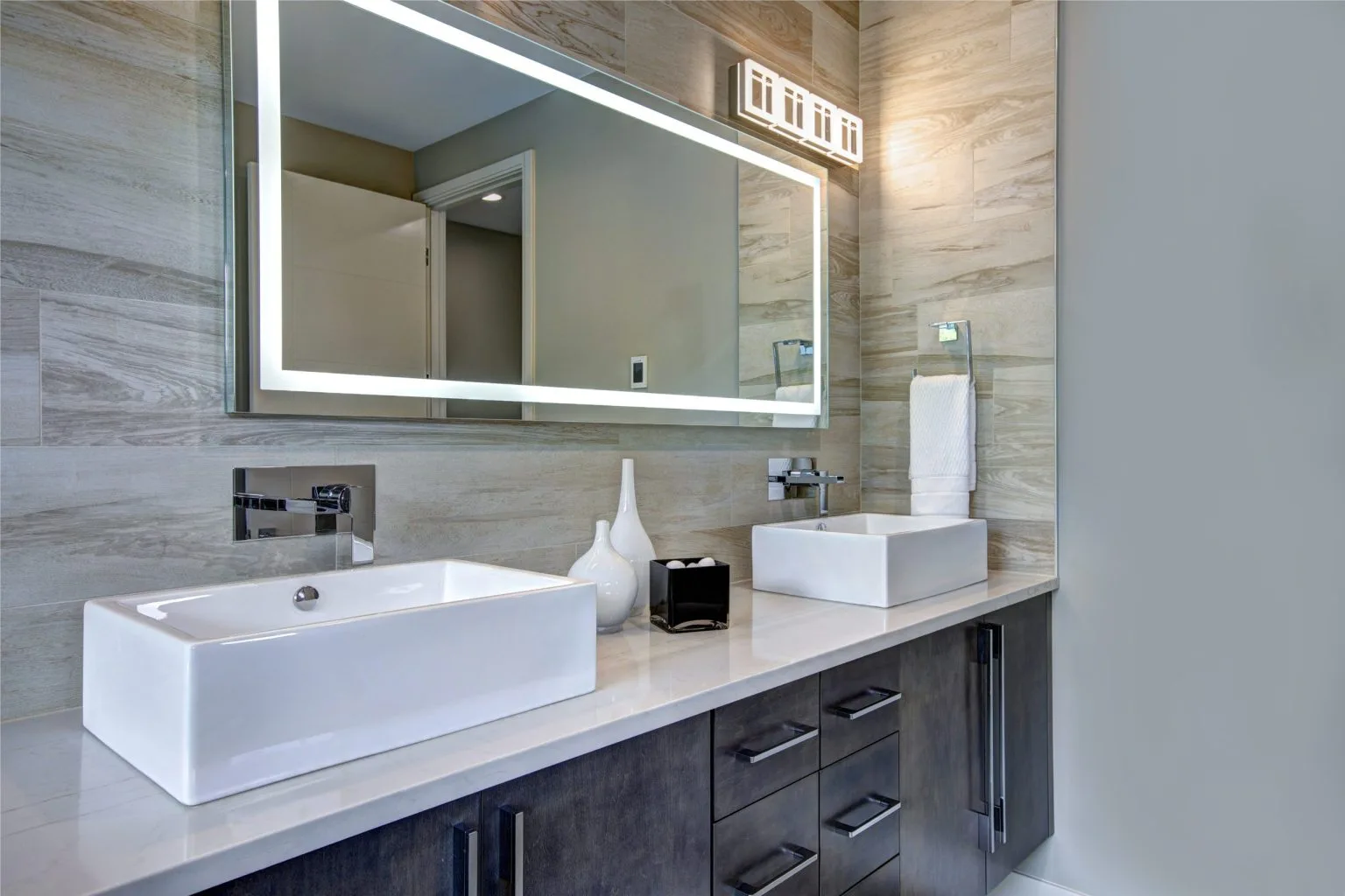 LED backlit bathroom mirror installed above twin vessel basins in a Dubai villa