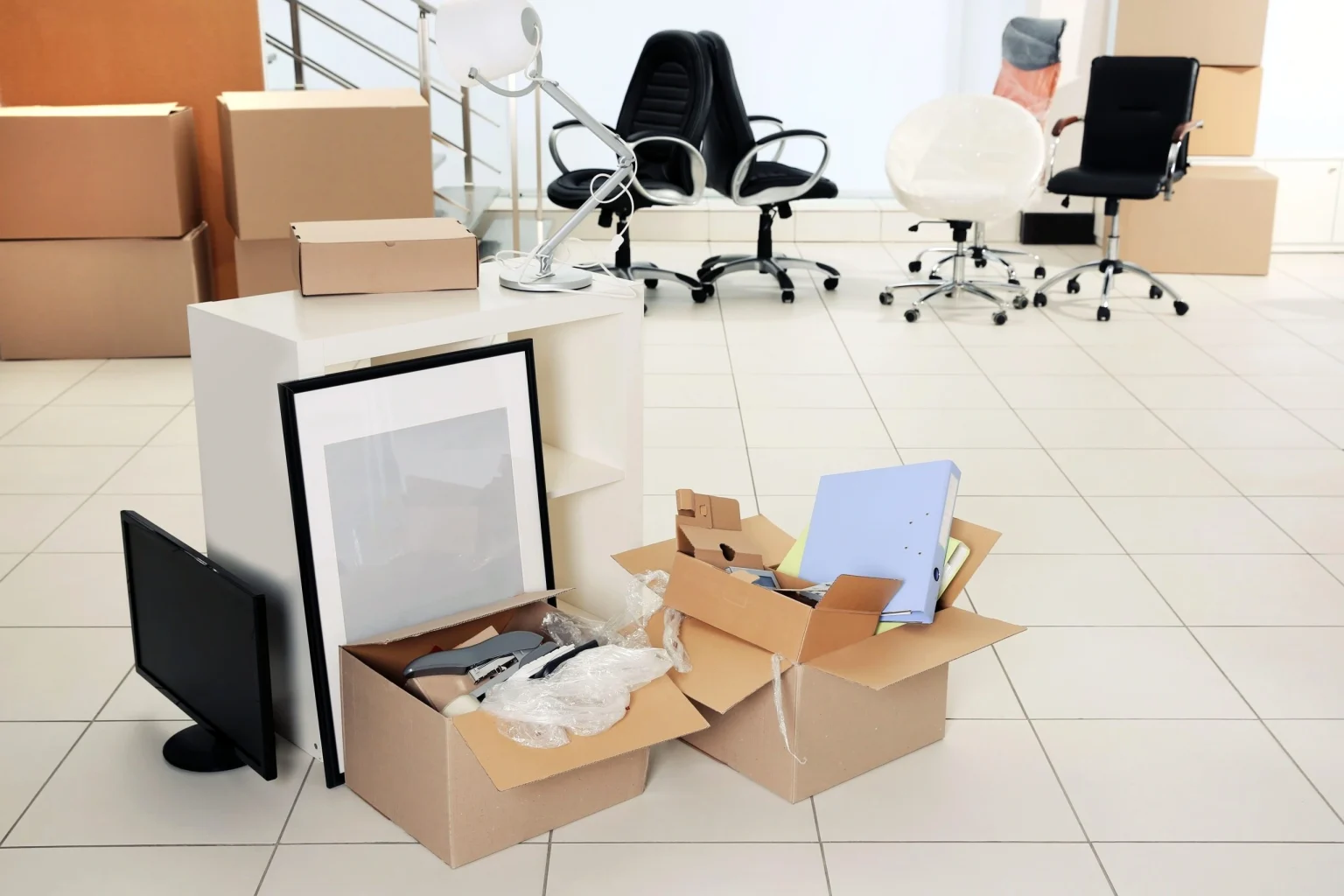 Office furniture, framed pictures and cartons packed for an office relocation in Dubai