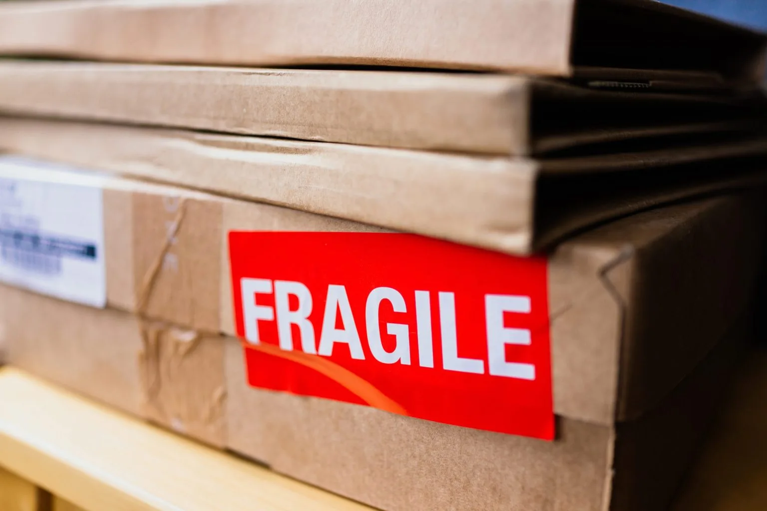 Close-up of a fragile label on a carton packed by movers and packers in Dubai