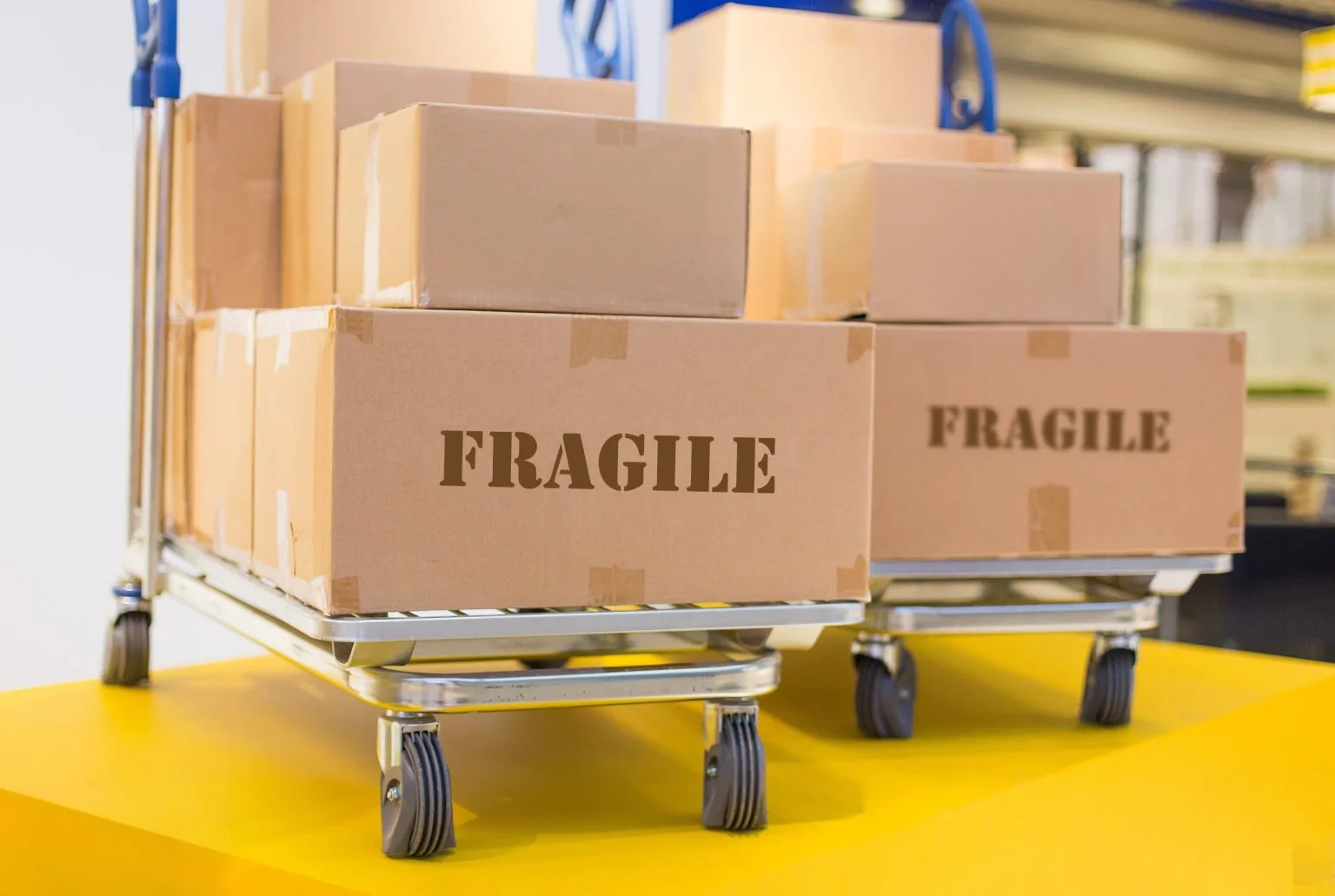 Boxes marked fragile stacked on wheeled trolleys ready for a Dubai house move