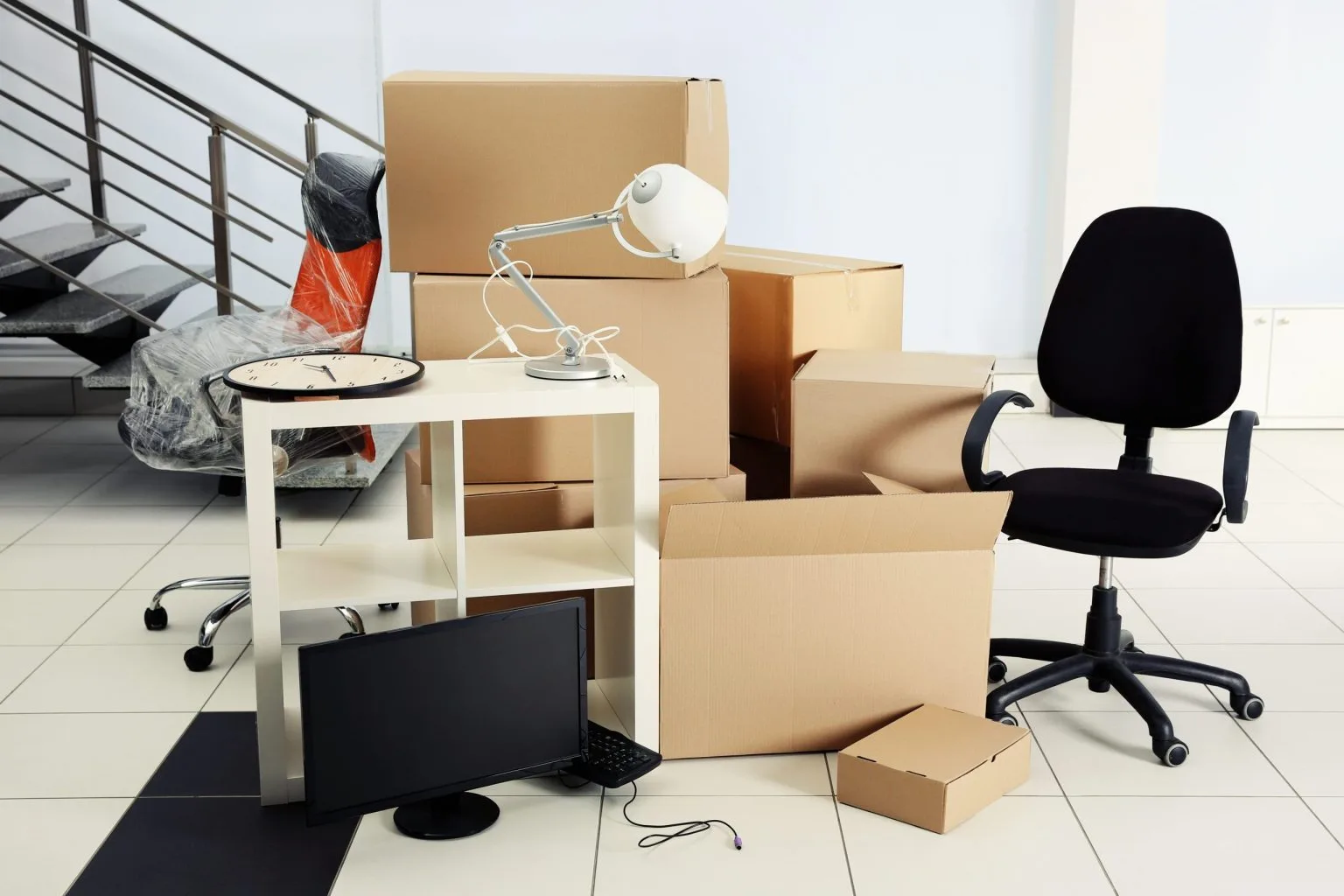 Desk, lamp, chair and cartons staged for a Dubai office relocation