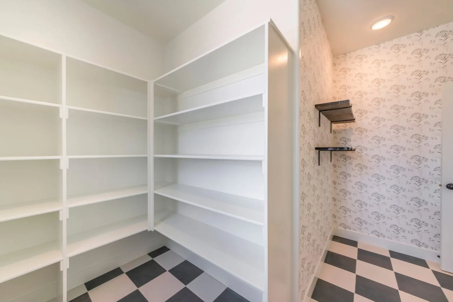Corner pantry room with white open shelving and easy-clean tiled flooring
