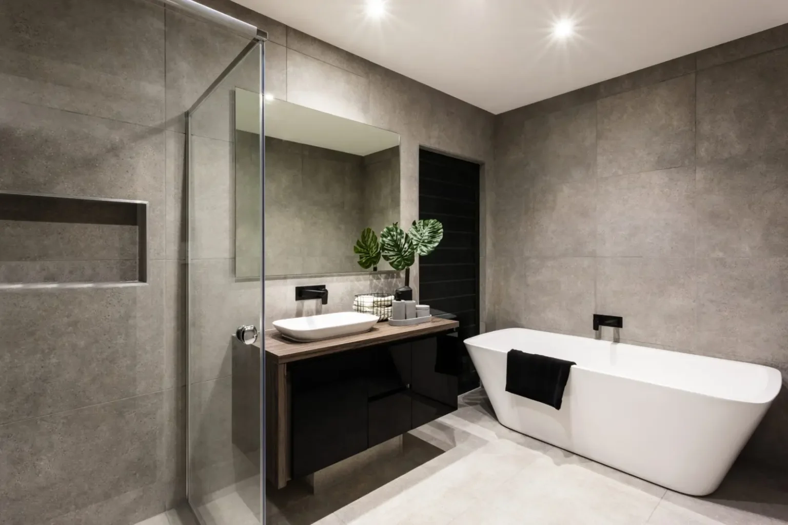 Grey concrete look bathroom with a freestanding tub in a Dubai bathroom remodel