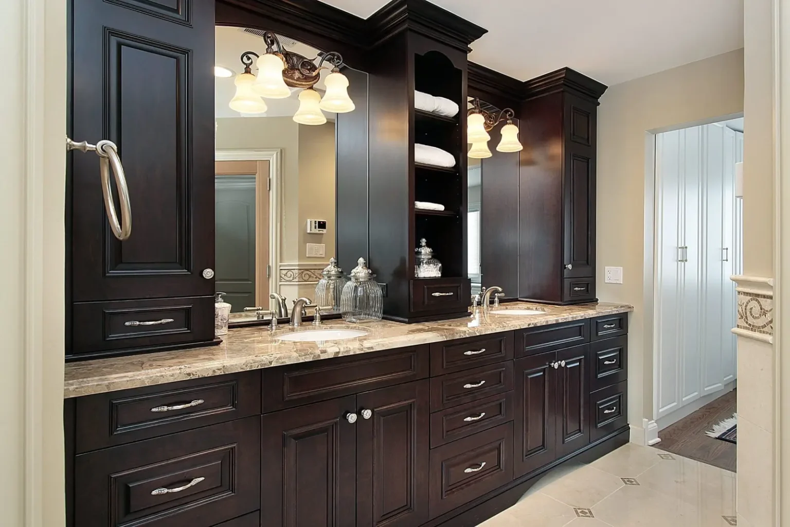 Luxury bathroom with custom dark wood joinery and large format tiling in Dubai