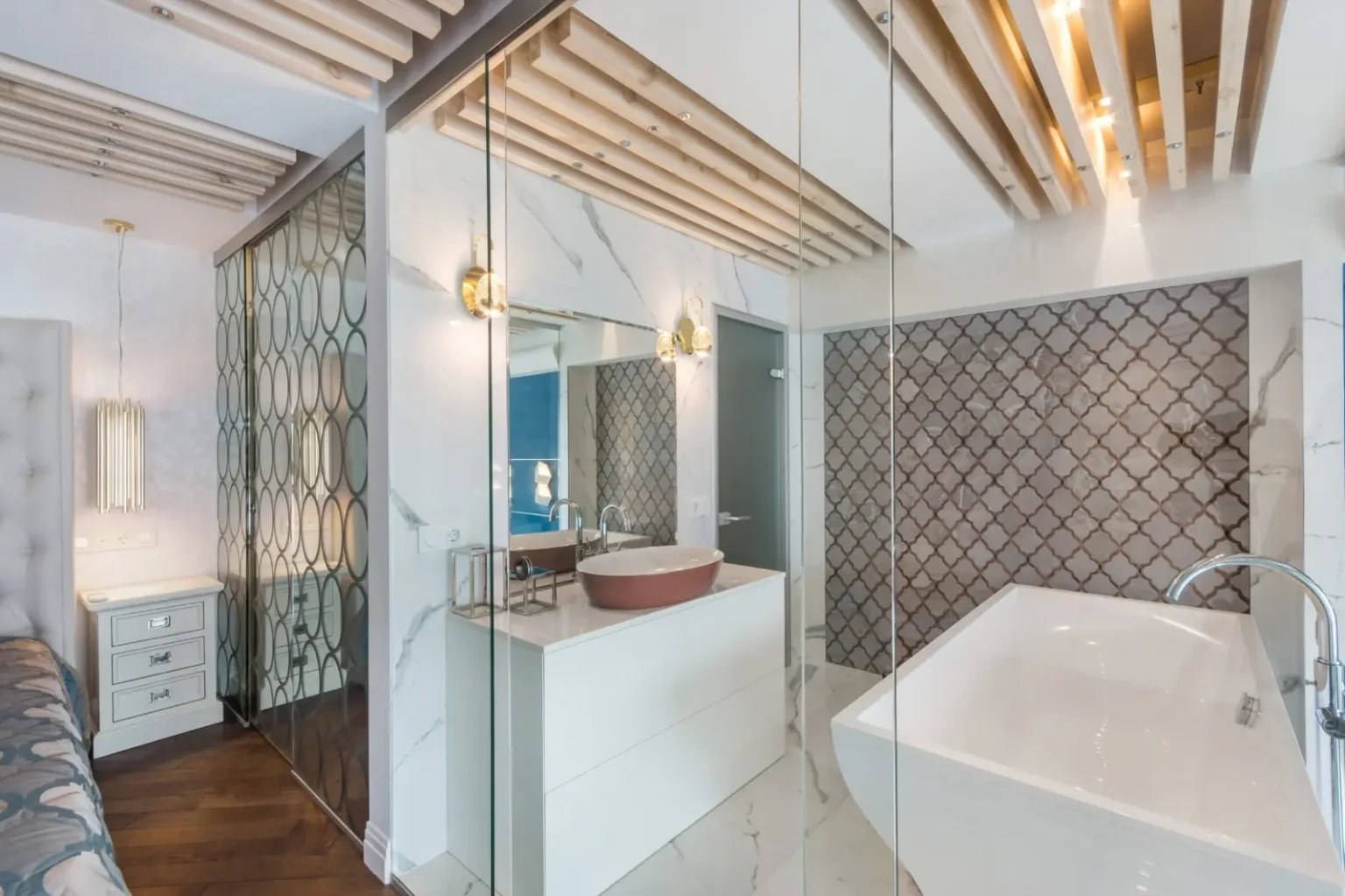 Marble ensuite behind a frameless glass partition, opening directly off the master bedroom