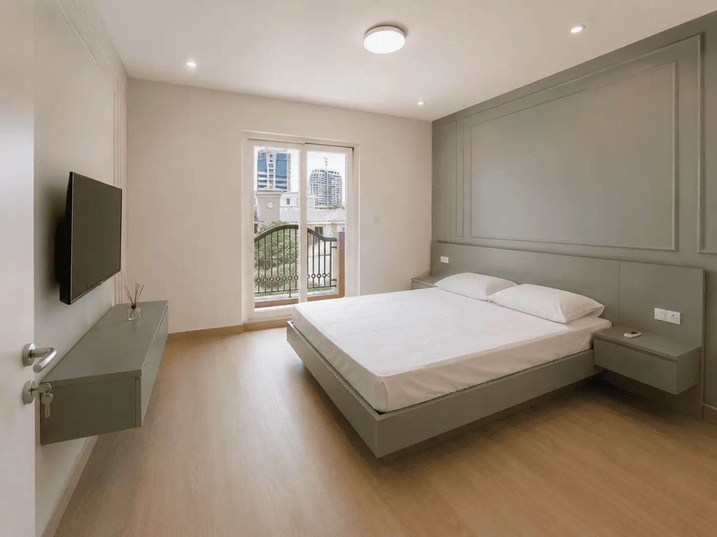 Bedroom renovation with sage green panelled feature wall, floating bed and balcony in Victory Heights villa, Dubai