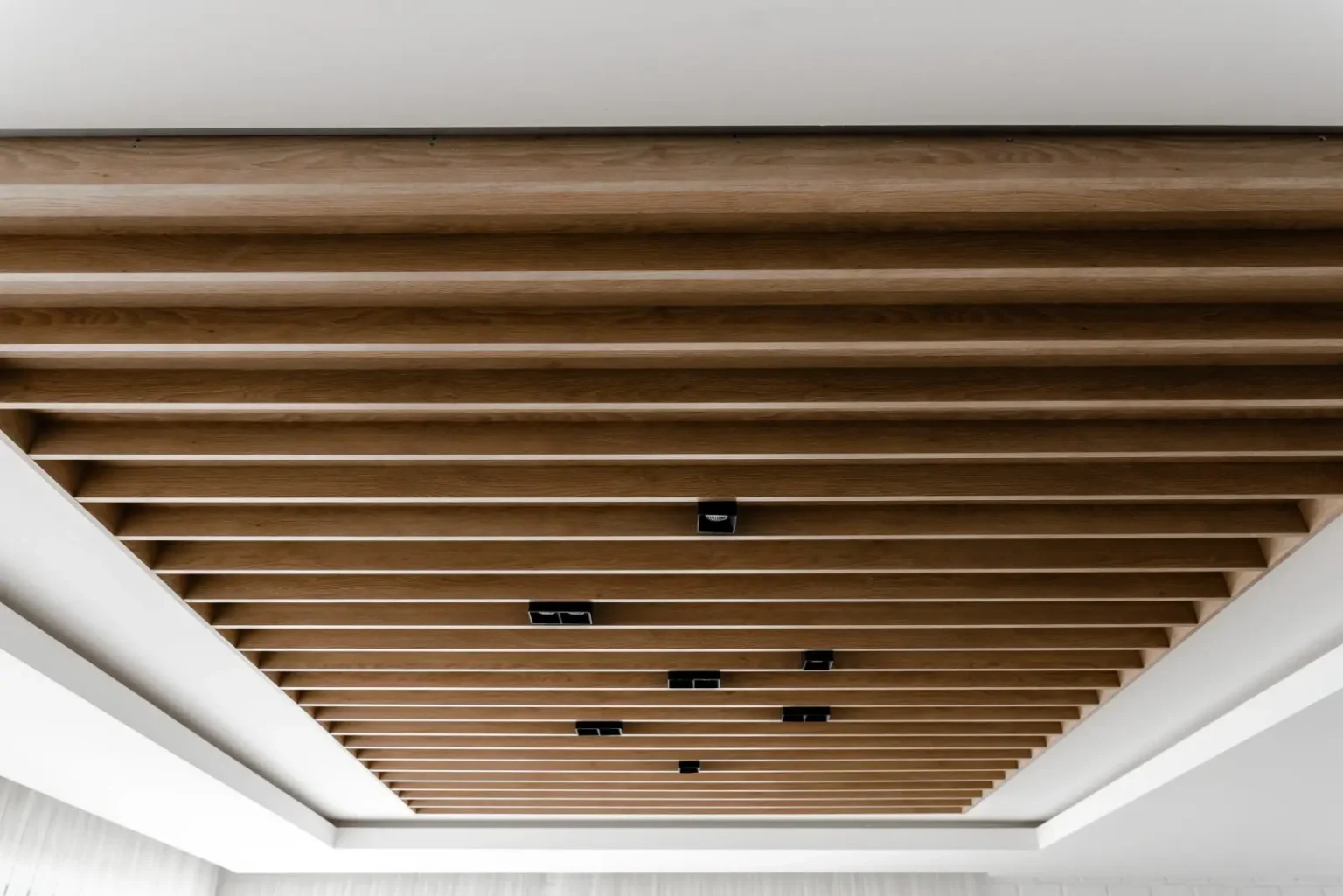 Wooden slat ceiling with recessed spotlights in a Dubai interior