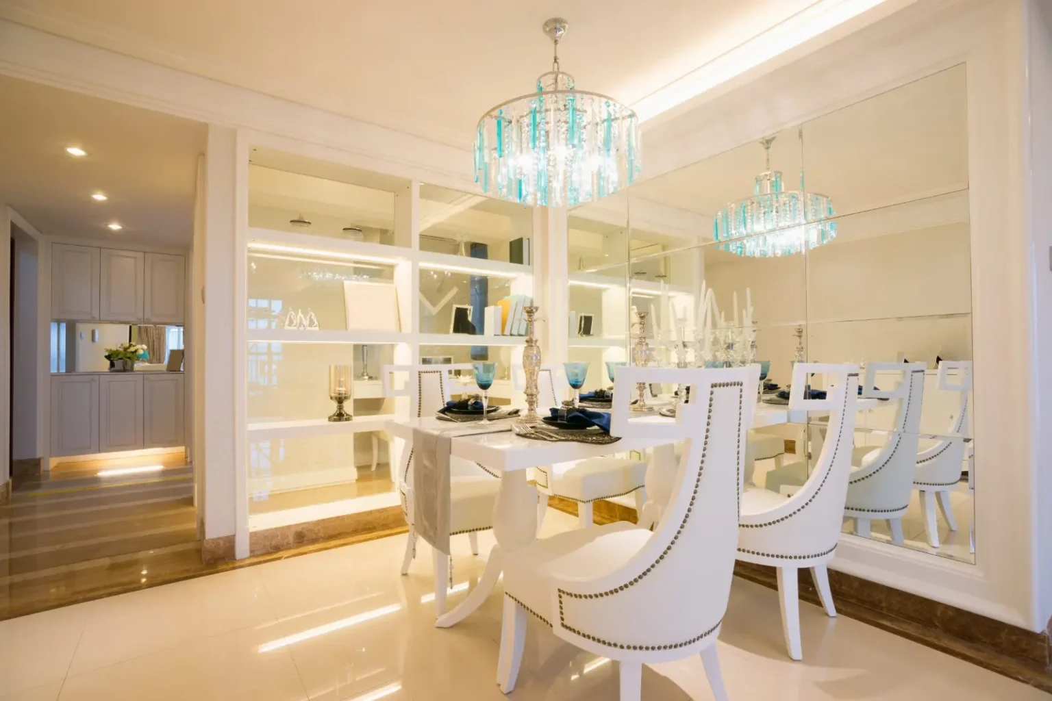 Luxury dining room with mirrored display walls and twin crystal chandeliers