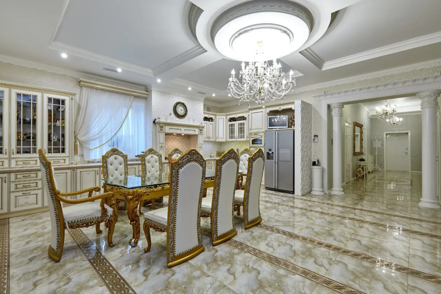 Dining room renovation in Dubai – formal villa dining room with a crystal chandelier and marble floor