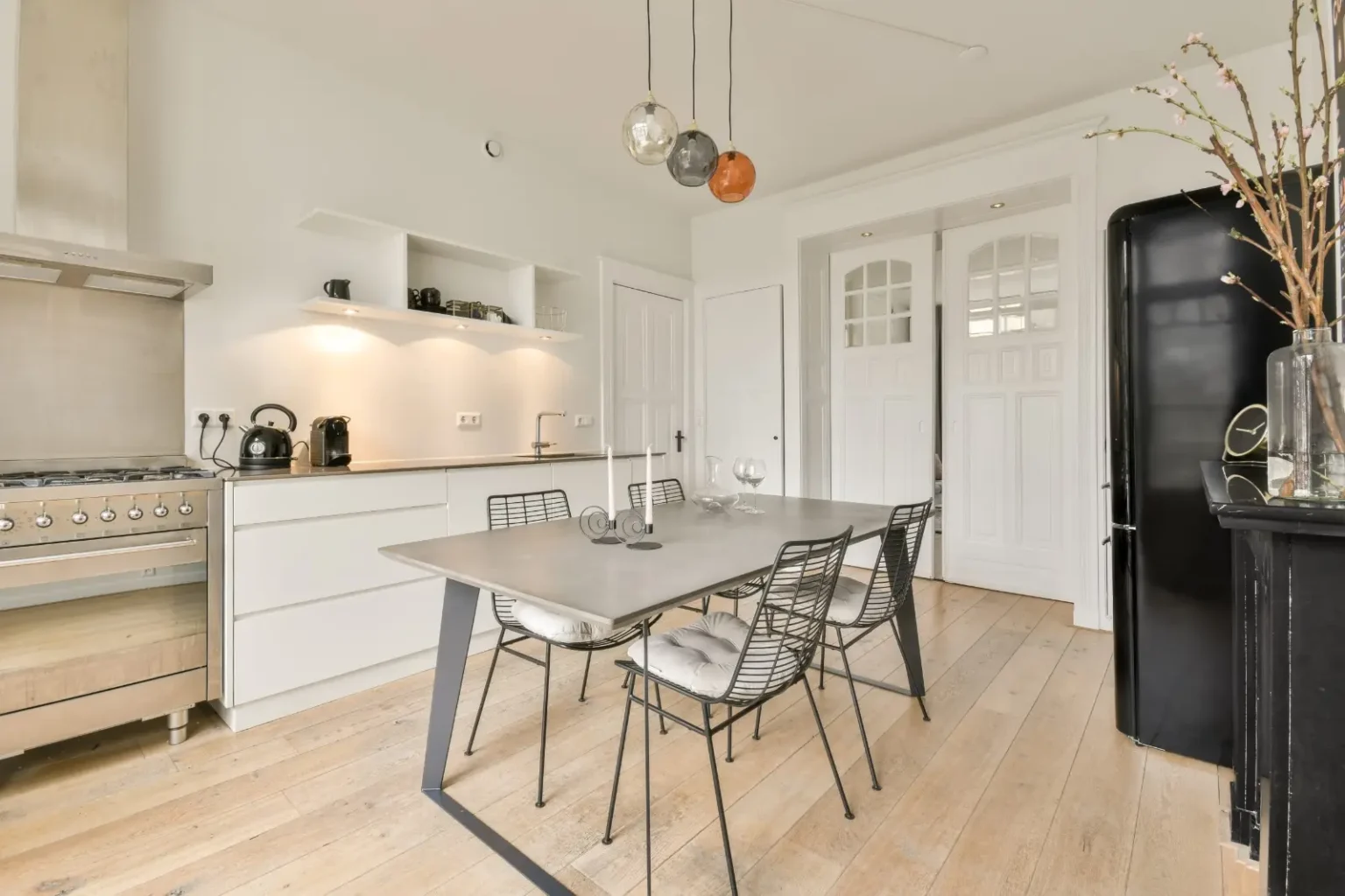 Kitchen and dining room separated by glass-panelled internal doors rather than a wall