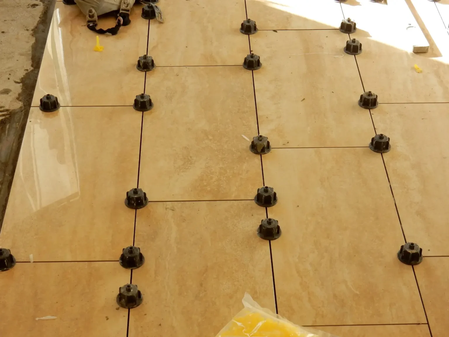Natural stone floor tiles being installed on a prepared substrate in Dubai