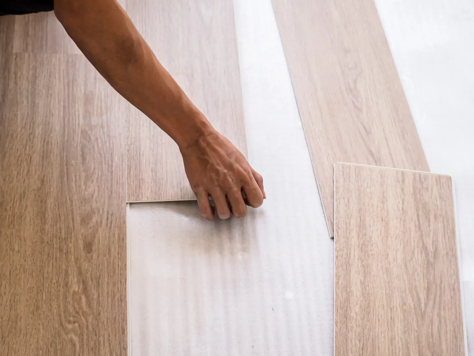 Luxury vinyl plank LVT flooring being installed over a prepared base in Dubai