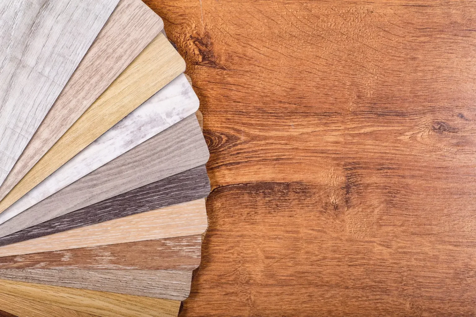 Vinyl and wood flooring samples laid out for selection by a flooring company in Dubai