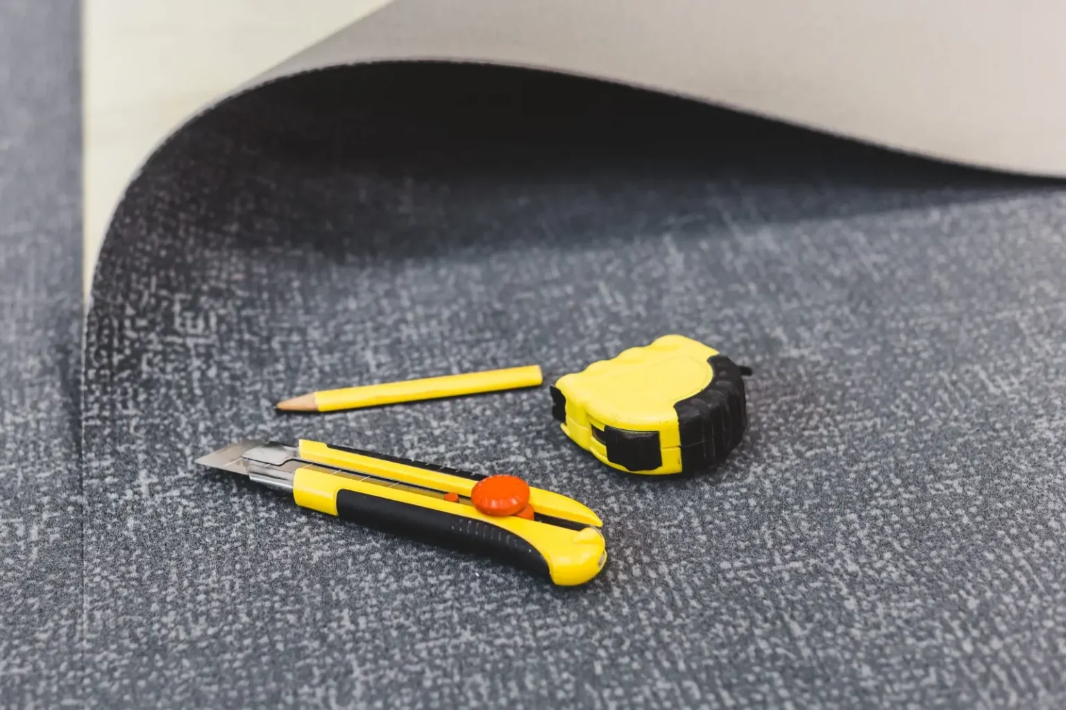 Carpet tile installation tools laid out for a Dubai office flooring project