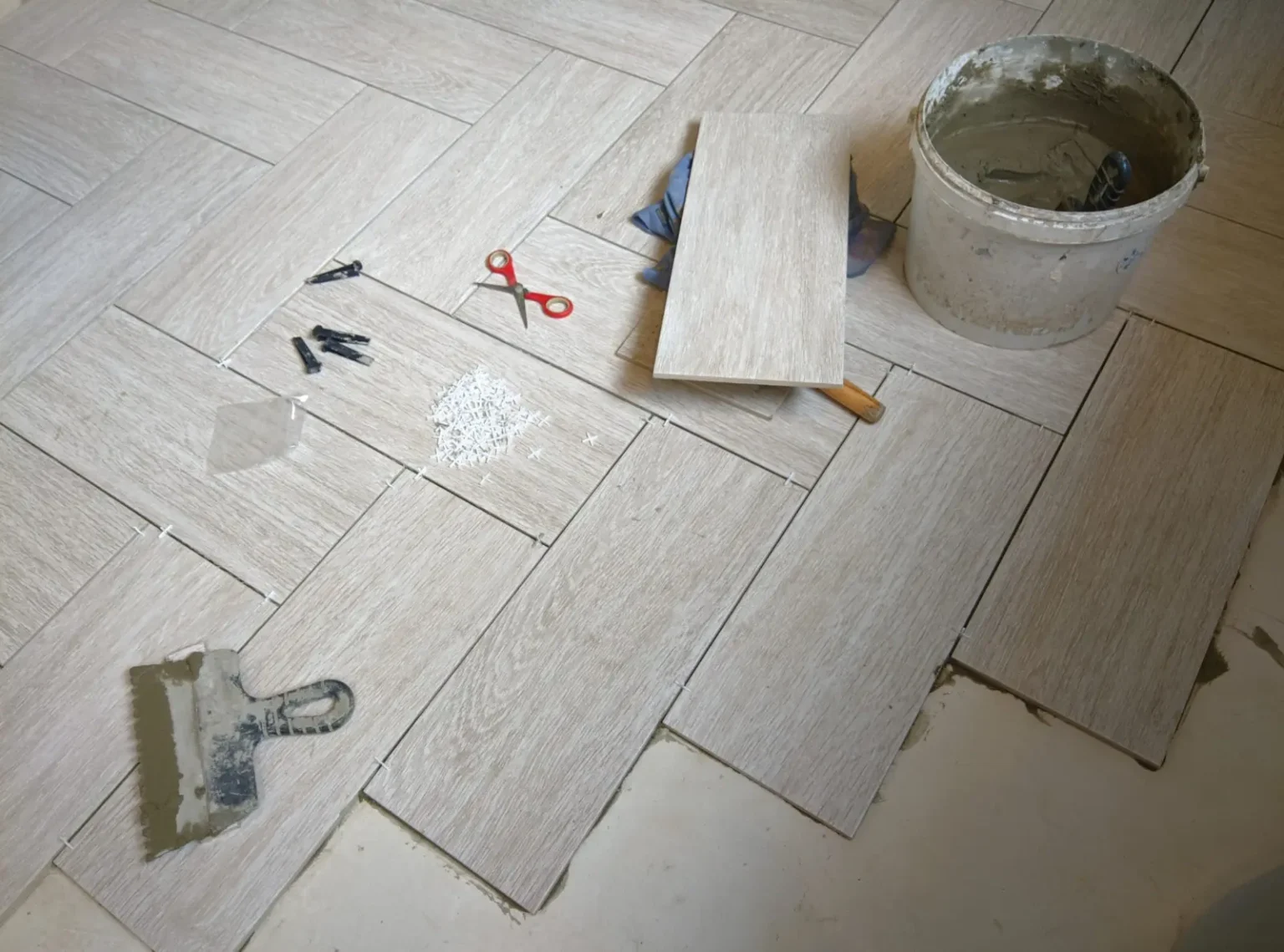 Wood look porcelain tile flooring being installed in a Dubai home