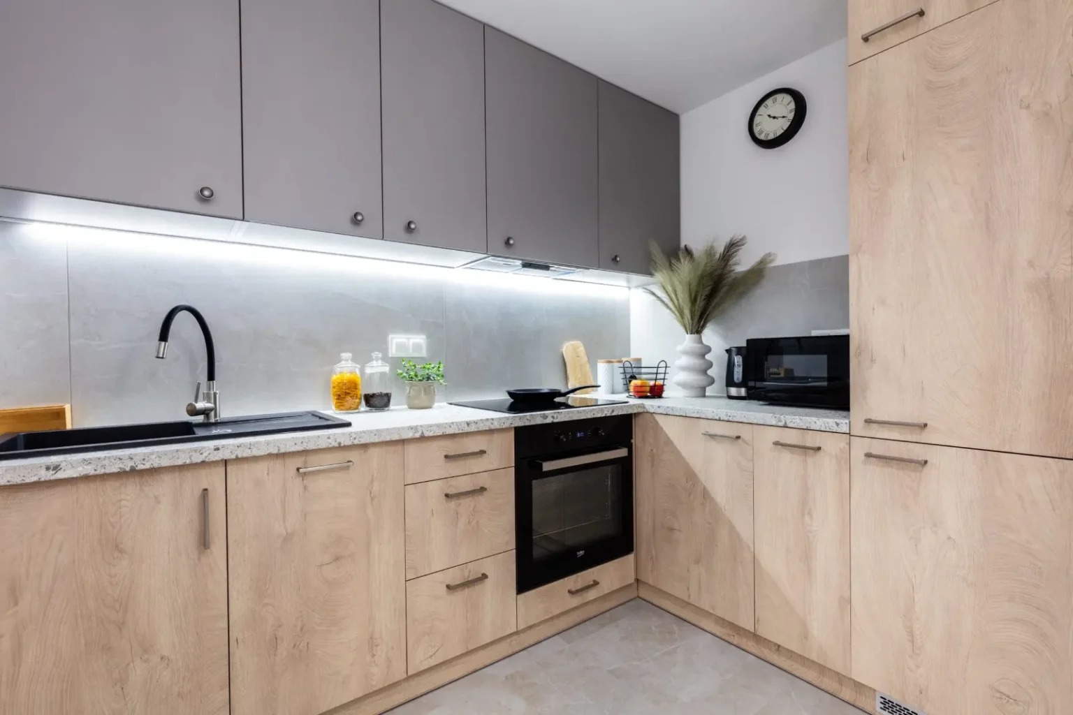 Custom wood grain and grey fitted kitchen cabinets built by a joinery workshop in Dubai