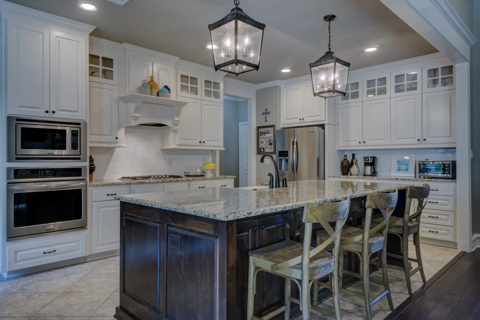 Classic kitchen design and build in Dubai with a dark island, granite worktop and pendant lighting